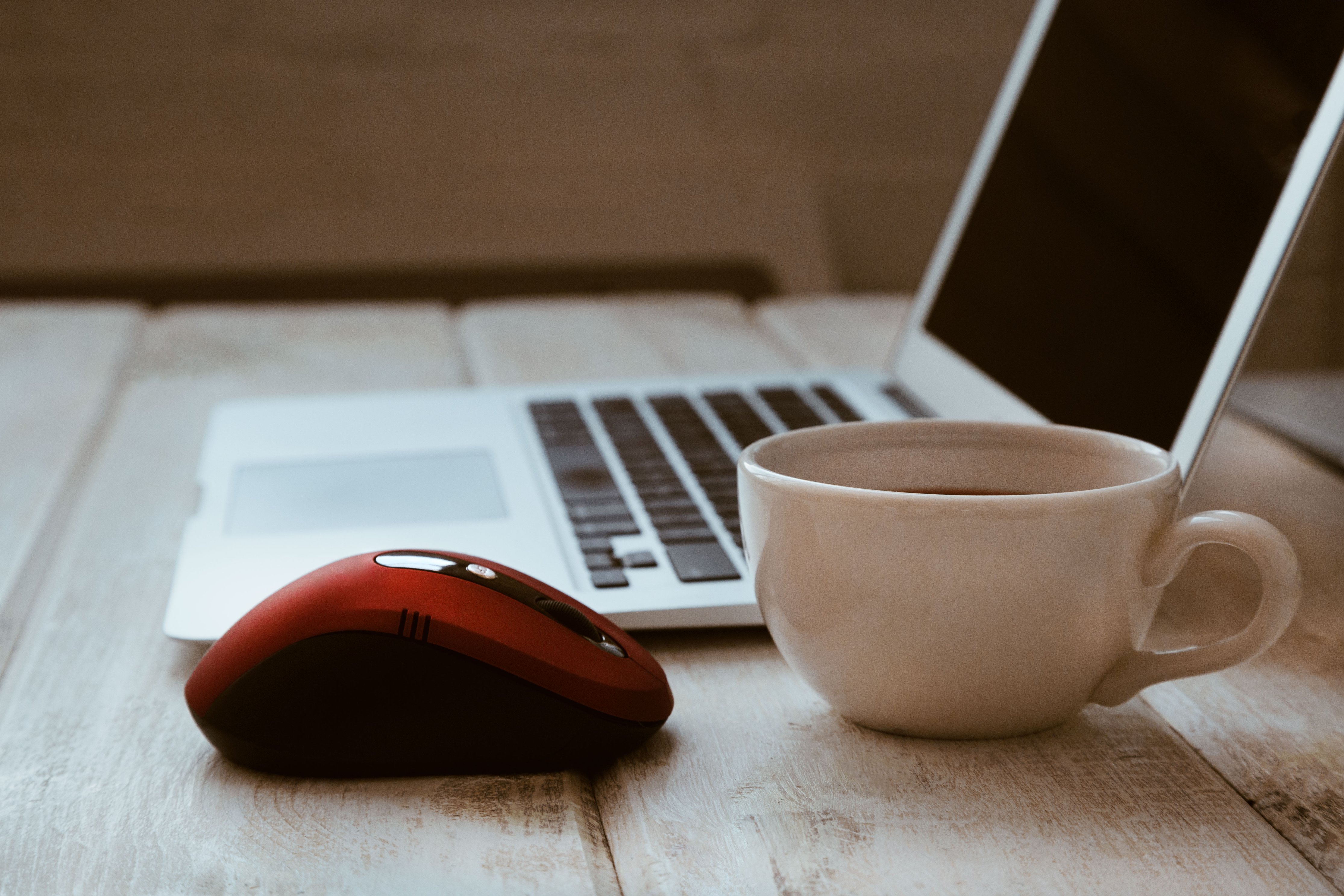 stock photo of a computer with a red mouse ad white coffee cup